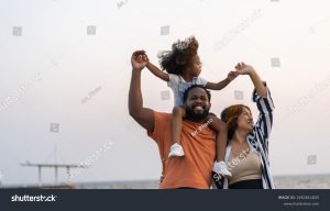 happy family playing with daughter